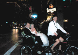 wedding couple riding in pedicab