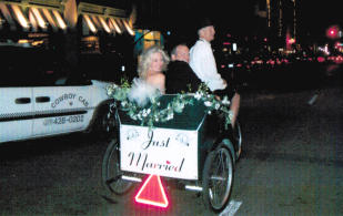 wedding couple riding in pedicab